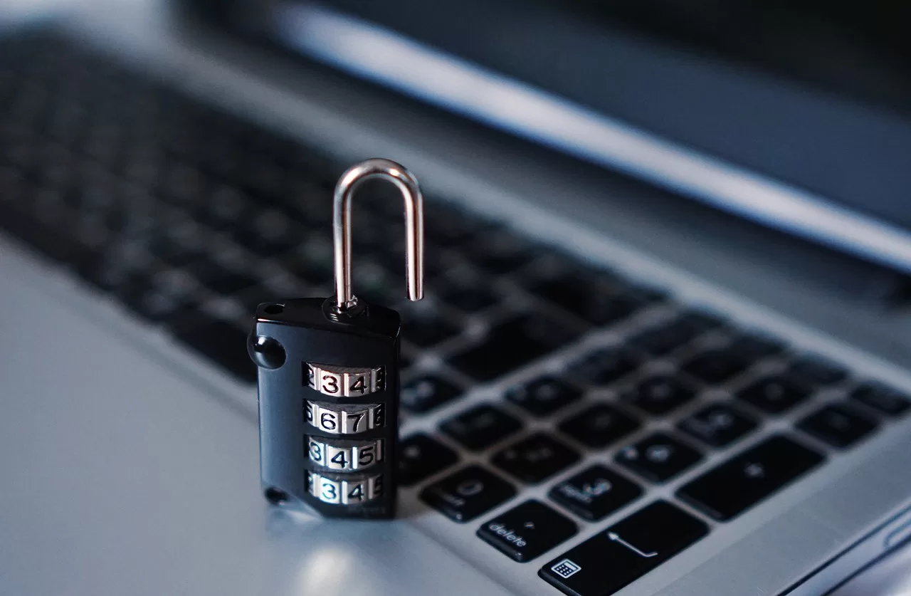 Data Breach Management Blog Image - Close up of a laptop keyboard with a combination padlock on top