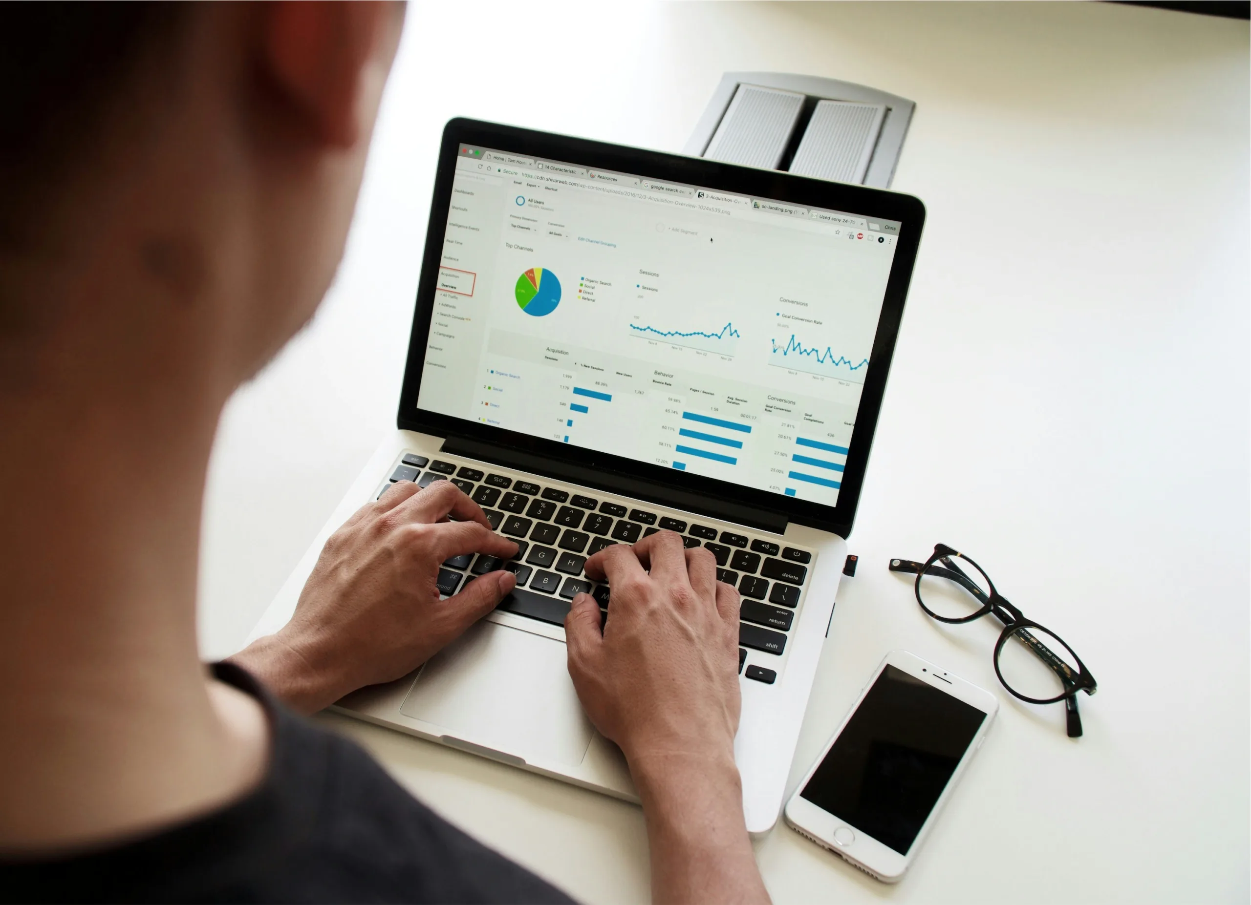 Person analysing digital marketing data on a laptop