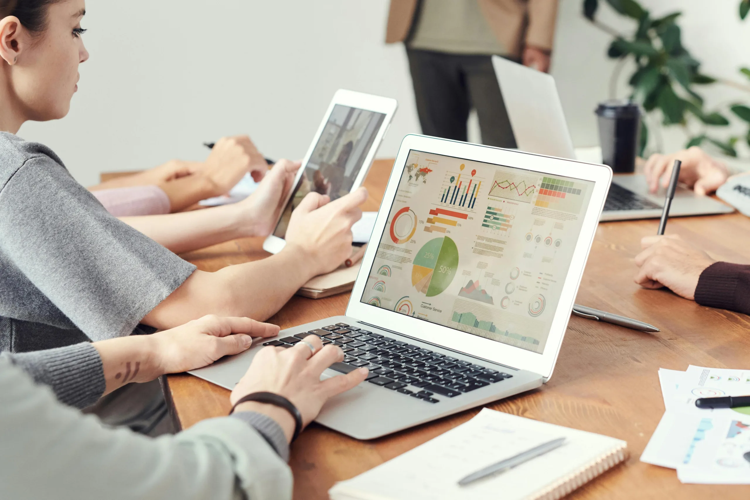 Team working with laptops and charts, highlighting why clean data and data quality matter for clear business decisions.