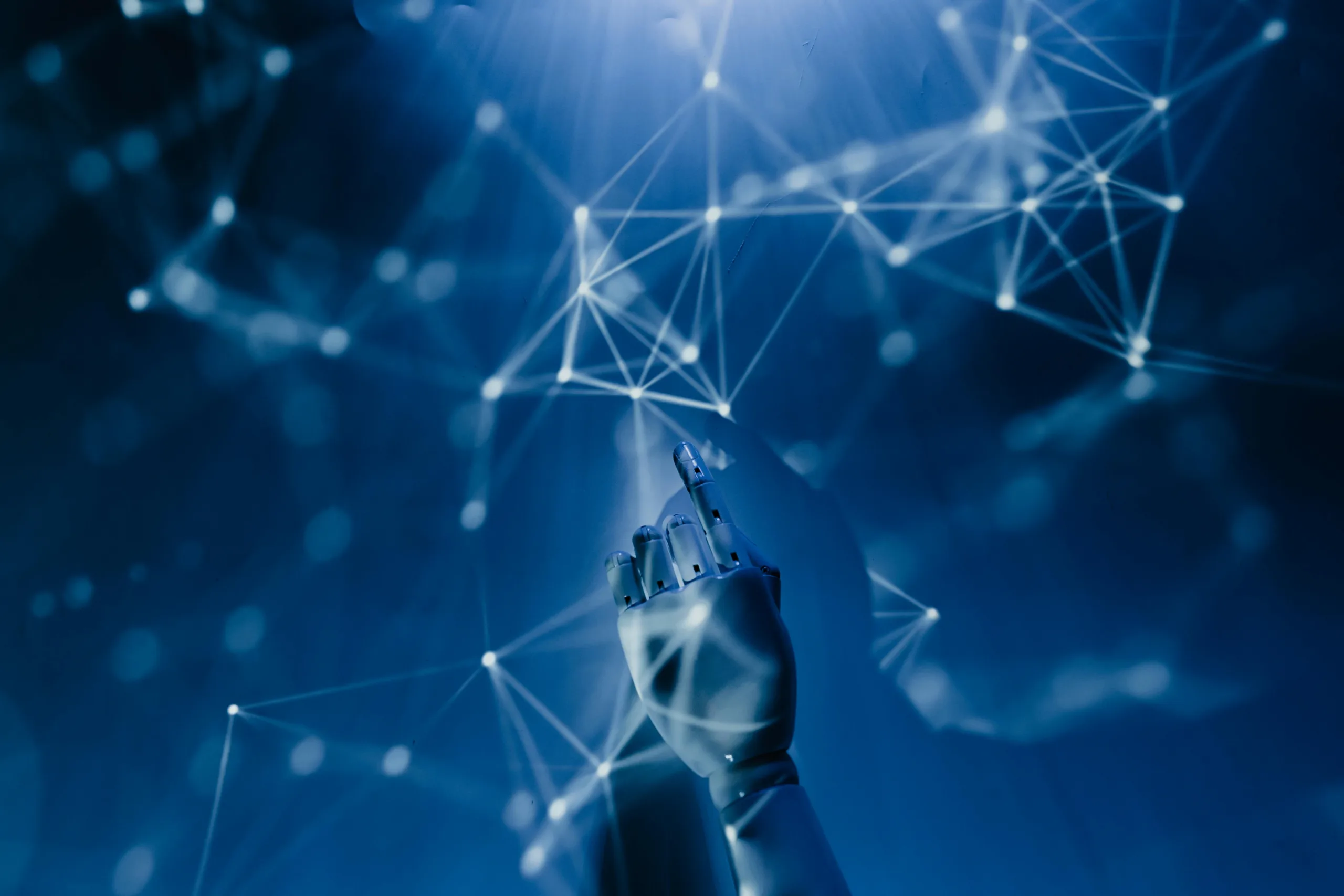 Robotic hand pointing at digital network connections, representing the future of AI tools in 2025.