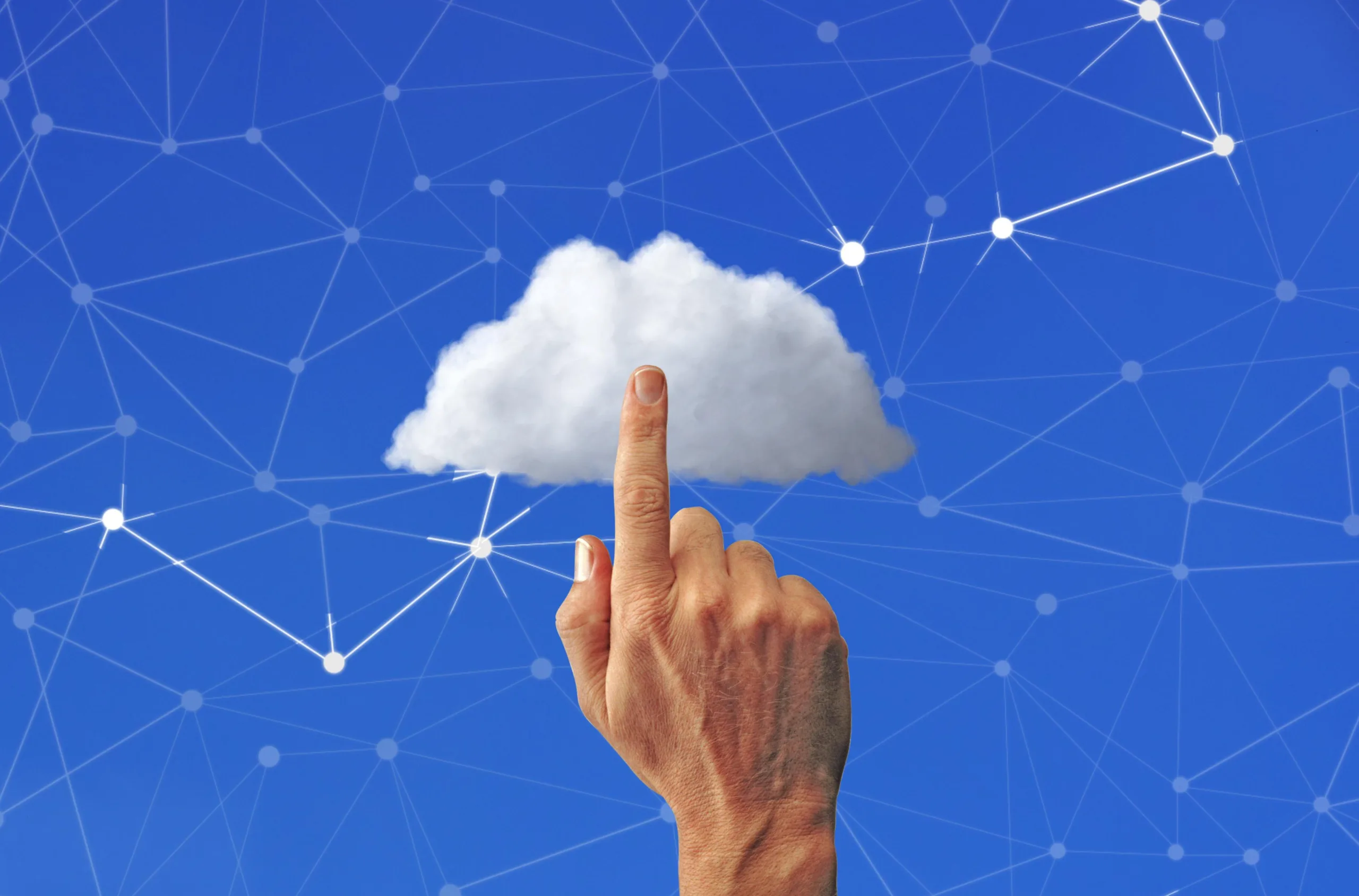 A hand pointing an index finger upward toward a fluffy white cloud against a blue sky with connected digital network lines.