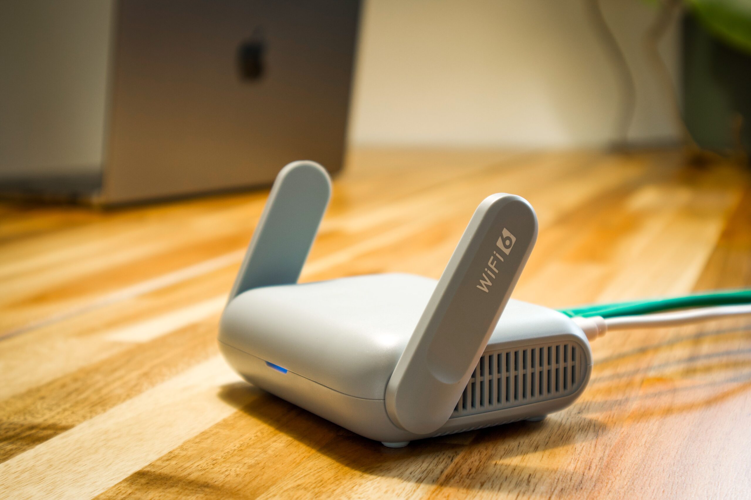 Wi-Fi 6 wireless router on a desk, representing secure business Wi-Fi and guest network separation.